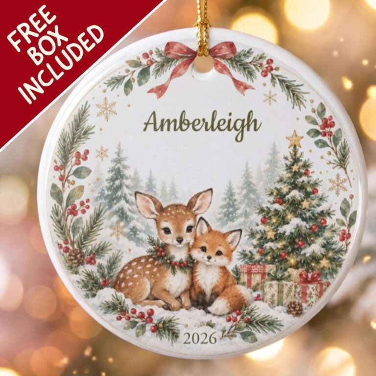 Personalized ceramic ornament with a fawn and a fox in the snow beside a Christmas tree